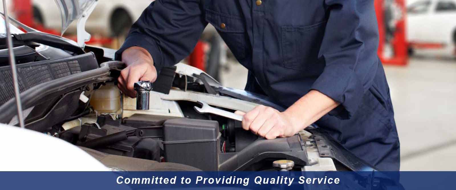 Inside Auto Comp Diag and Repair shop showing professional automotive service bay with lifts and equipment